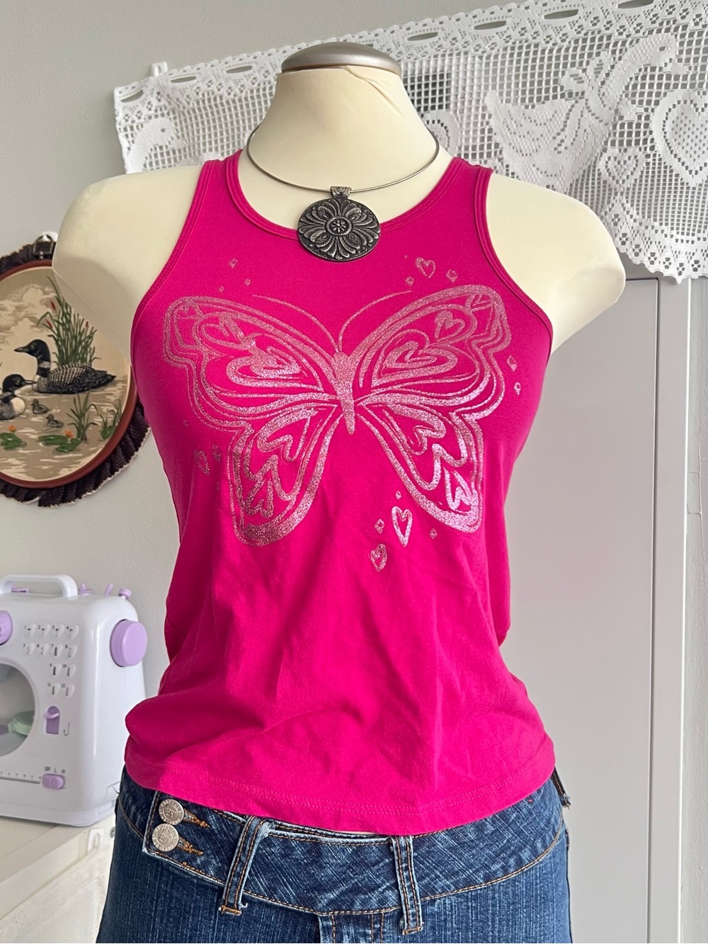 Y2K style pink butterfly tank top with silver butterfly graphic and small hearts